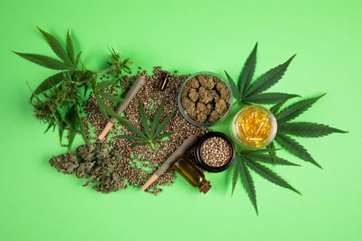 Composition with marijuana leaves, bottle of oil, cannabis on cbd