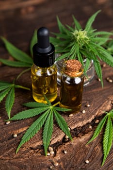 Cannabis oil bottle and marijuana leaves