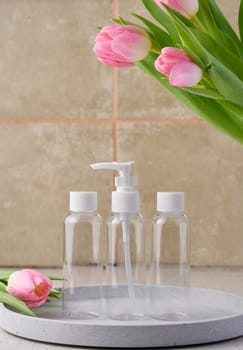 Transparent plastic container with a dispenser on the table. Bottle for liquid soap, shampoo