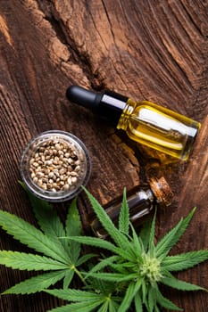 Cannabis oil bottle and marijuana leaves