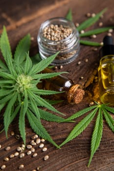 Cannabis oil bottle and marijuana leaves