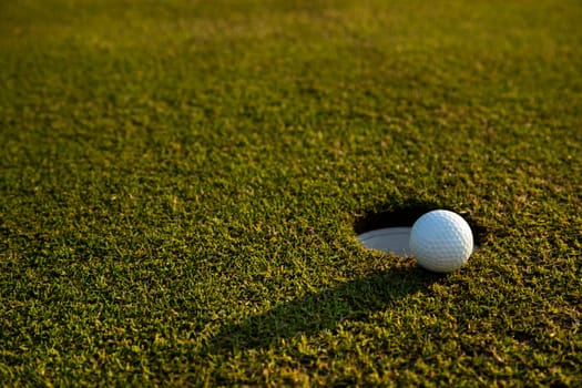 Golf ball and clubs in golf field