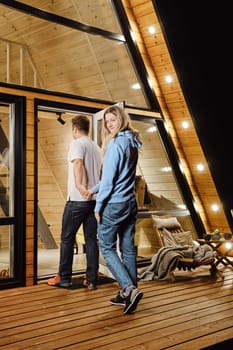 A husband and wife enter tiny house after an evening walk