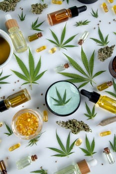 Top view of marijuana leaves and cannabis buds on white background