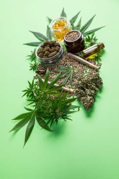 Composition with marijuana leaves, bottle of oil, cannabis on cbd