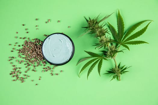 Composition with marijuana leaves, bottle of oil, cannabis on cbd