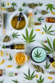 Top view of marijuana leaves and cannabis buds on white background