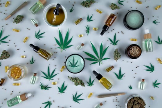 Top view of marijuana leaves and cannabis buds on white background