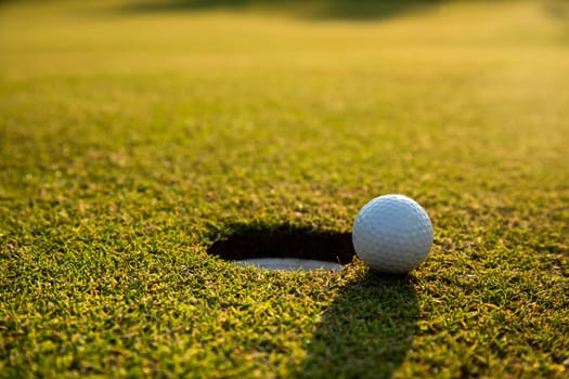 Closeup Golf ball on green grass on course