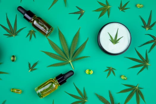 Flat lay composition with marijuana leaves, bottle of oil, marijuana and cannabis on cbd
