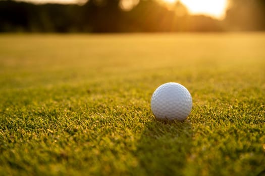 Golf ball and clubs in golf field