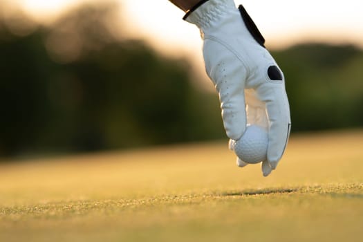 Golf course with ball and grass on close up of a hand     ,grass,golfer,golfing,sky,nature,ball,object,play,blue,fairway,closeup,club,outdoor     ,competition,recreation,background,color,summer