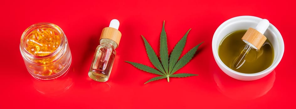 Composition with marijuana leaves, bottle of oil, cannabis on cbd