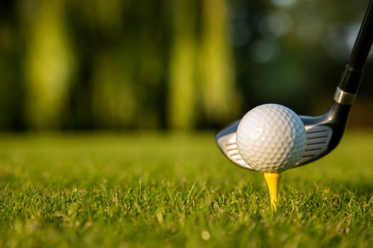 Golf player playing in a golf club on a beautiful sunset in the evening