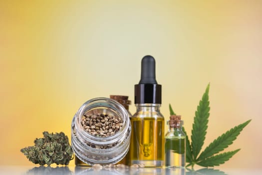 Cannabis oil bottle and marijuana leaves