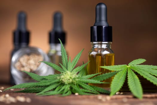 Cannabis oil bottle and marijuana leaves