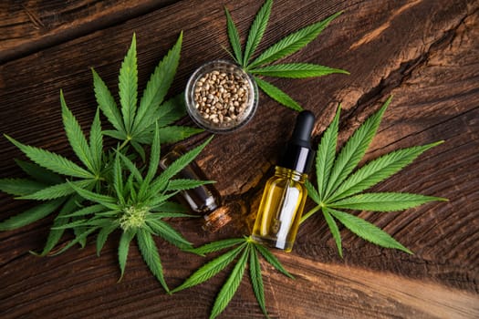 Cannabis oil bottle and marijuana leaves