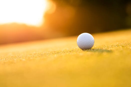 Golf ball and clubs in golf field