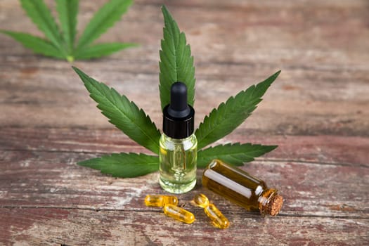 Bottles with hemp oil and cannabis leaves, marijuana