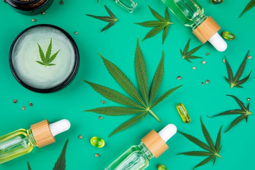 Flat lay composition with marijuana leaves, bottle of oil, marijuana and cannabis on cbd