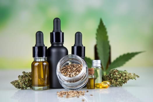 Hemp cbd oil, cannabis leaves, hemp seeds and bottles of oil