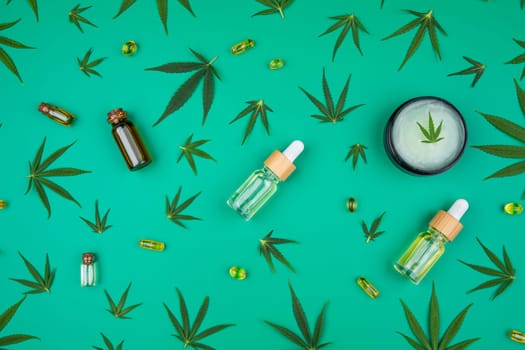 Flat lay composition of marijuana and hemp seeds on color green background