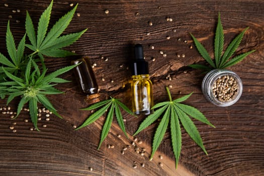 Cannabis oil bottle and marijuana leaves