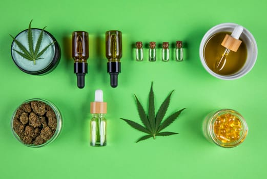 Composition with marijuana leaves, bottle of oil, cannabis on cbd