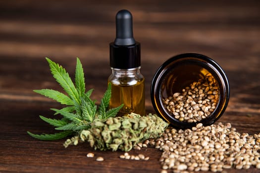 Hemp oil and marijuana leaves on extract cbd