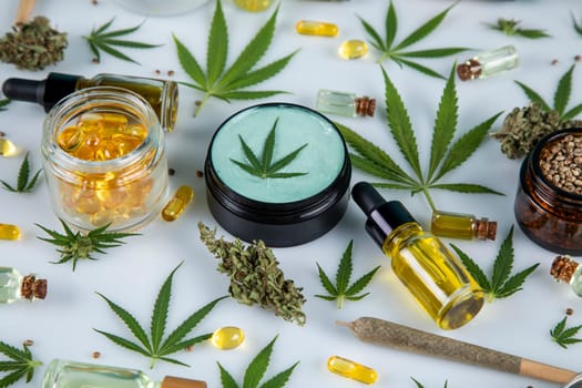 Top view of marijuana leaves and cannabis buds on white background