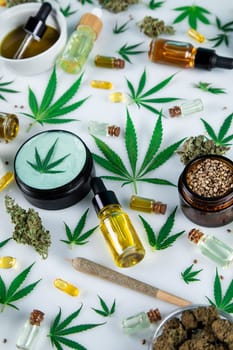 Cannabis hemp oil bottle with hemp seeds, hemp leaf, cannabis oil and marijuana