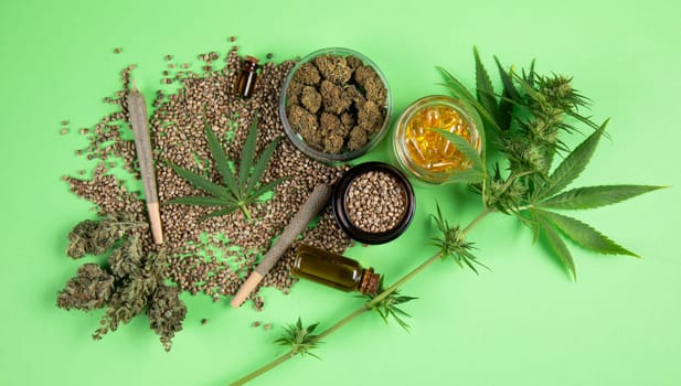 Composition with marijuana leaves, bottle of oil, cannabis on cbd