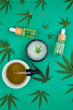 Flat lay composition with marijuana leaves, bottle of oil, marijuana and cannabis on cbd