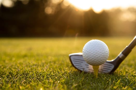 Playing a golf on a beautiful sunset in the evening
