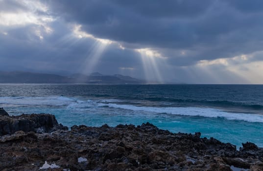 Beautiful sunrays on the Atlantic coast in Las Palmas de Gran Canaria, view from Las Canteras beach