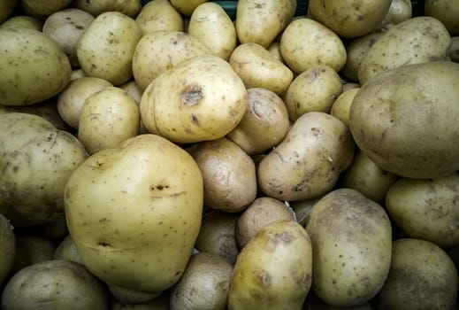 Detail of raw potatoes in a market, healthy food, vegan