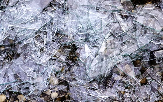 Detail of pieces of broken glass on the ground, crime and destruction