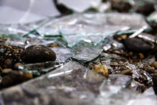Detail of pieces of broken glass on the ground, crime and destruction