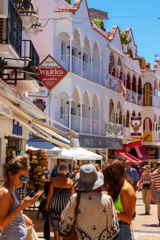 TORREMOLINOS, SPAIN - May 21, 2019. Calle San Miguel is the most popular shopping street in Torremolinos. This street offers many shops, cafes and ice bars and the tourists love to stroll through it.