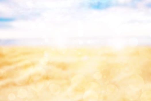 Abstract desert landscape background with yellow sand dust and a glistening sun with blue turquoise sky and bokeh circles. Beautiful texture. Travel and tourism advertisement.