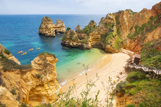Landscape photography overlooking Praia do Camilo and canoes near Lagos, famous beach in the Algarve, Portugal