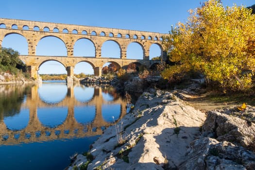 The Pont du Gard over Gardon river. Ancient Roman three-tiered aqueduct bridge. Photo taken in Vers-Pont-du-Gard, Provence, southern France