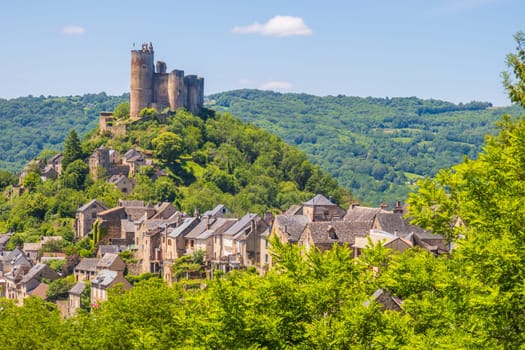 Castle of Najac towering above village houses, one of the most beautiful villages of France photographed in Occitanie region