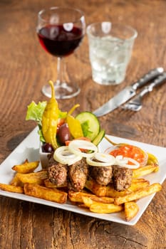cevapcici with french fries and onion rings