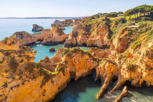 View over the jagged cliffs of Praia do Ferta beach near Alvor, Portugal