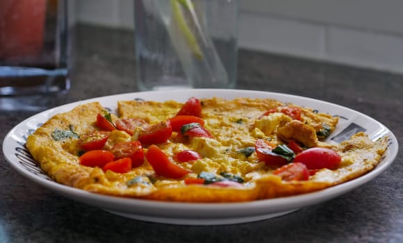 a plate of pasta with cherry tomatoes