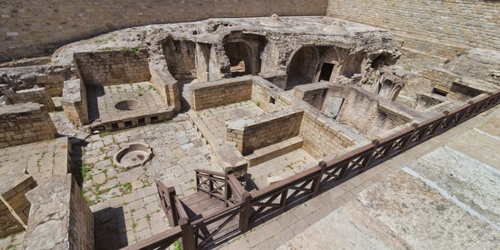 A view of the ruins of the bathhouse within the Shirvanshahs Palace in Baku, Azerbaijan. The stone structure shows the remnants of a once grand and functional building