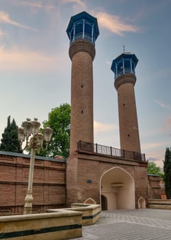 A view of the Juma Mosque of Ganja, Azerbaijan, with its two tall minarets and red bricks facade