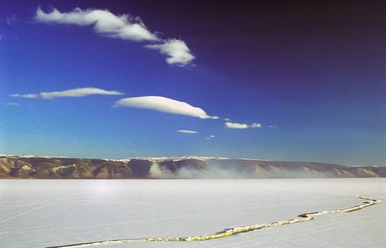 Winter on the Baikal, ice and snow on the lake. The beauty of the nature of Baikal in winter.