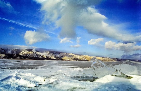 Winter on the Baikal, ice and snow on the lake. The beauty of the nature of Baikal in winter.